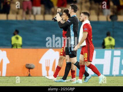 Belgium's Axel Witsel, Belgium's goalkeeper Thibaut Courtois and Belgium's Eden Hazard celebrate after winning the round of 16 game of the Euro 2020 E Stock Photo