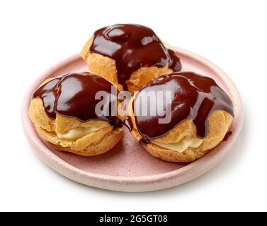 plate of freshly baked cream puffs isolated on white background Stock Photo