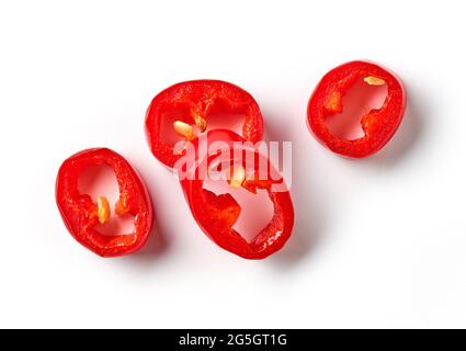 red hot chili pepper slices isolated on white background, top view Stock Photo