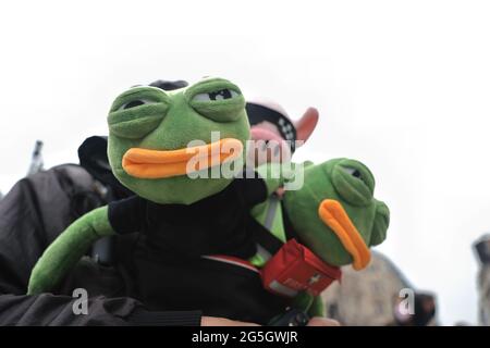 London, UK. 27th June, 2021. Participants with Pepe and the LIHKG pig, which were the symbol of the Hong Kong movement in 2019. A group of former Apple Daily Hong Kong journalists join force to produce a special edition to raise awareness of the end of press freedom in Hong Kong in response to the recent shut down of the publication due to the national security law. Credit: SOPA Images Limited/Alamy Live News Stock Photo