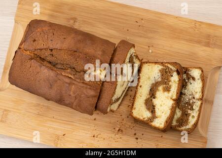 Fresh baked homemade pound, butter cake in loaf pan on slate stone plate  decor by pinecorn and walnuts Stock Photo - Alamy