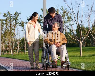 A happy family of three walking in the park high quality photo Stock Photo