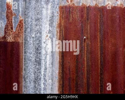 Old vintage rusty zinc texture abstract background. Beautiful red rust stain covered on zinc tile surface with copy space. Stock Photo