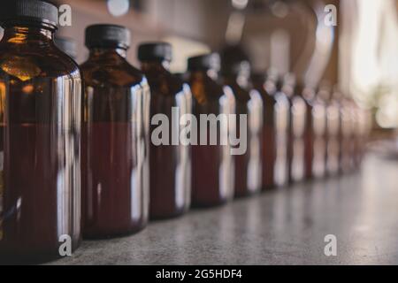 Row of various brown medicine bottle without copyspace label design pattern. Selective focus. Stock Photo