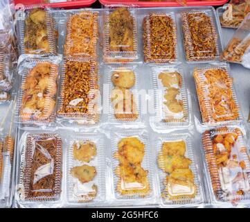 fried side dishes are sold in plastic mica wrap on the table Stock Photo