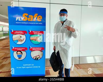30 Jan 2021, Air travel new rules, healthy and safe flight, Asian man in medical protection masks at airport terminal at New Delhi, India