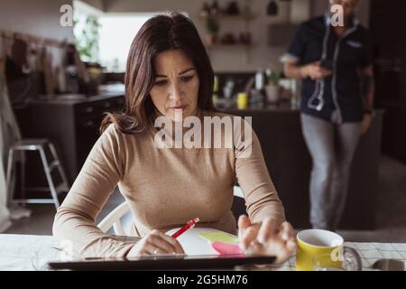 Businesswoman working on digital tablet at home office Stock Photo