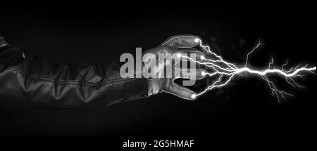 Hand shooting out a bolt of lightning - Dark and mysterious, isolated on black Stock Photo