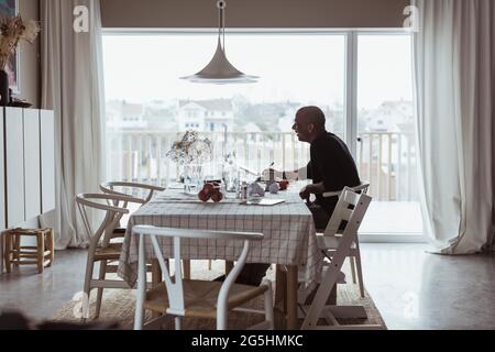 Businessman working on laptop at home Stock Photo