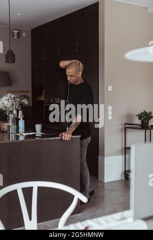 Businessman using digital tablet in kitchen at home Stock Photo