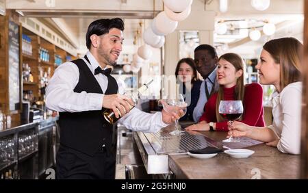 Barman serving drinks on bar Stock Photo