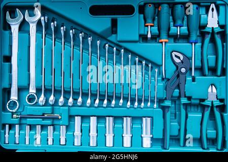 Set of new manual hand tools and wrenches for auto repair in green mechanic box. Stock Photo