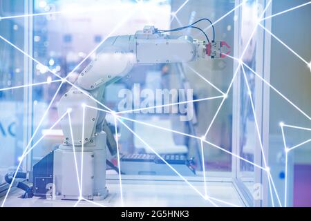 Automatic machine robot arm tool in manufacture factory. Concept smart Industrial 4.0 technology. Stock Photo