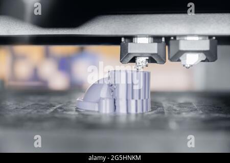 Modern 3D plastic printer printing figure close-up macro. Stock Photo