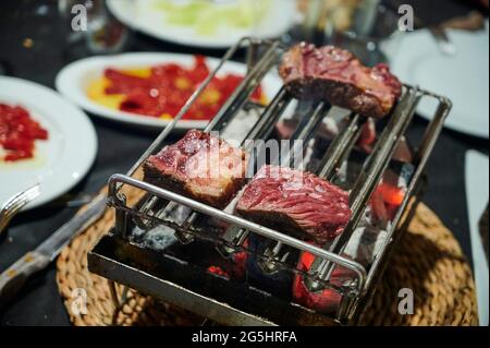 detail of red meat being made on the grill Stock Photo