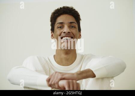 Portrait of cheerful young man against white background Stock Photo