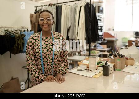Smiling African female fashion designer working in her studio Stock Photo