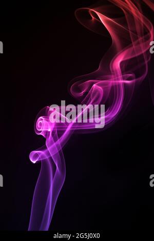 Blue with purple smoke isolated on black background. Stock Photo