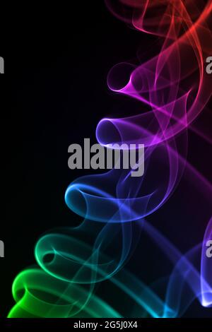 Colorful smoke isolated on black background. Stock Photo