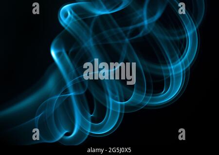 Blue smoke isolated on black background. Stock Photo