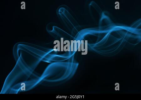 Blue smoke isolated on black background. Stock Photo