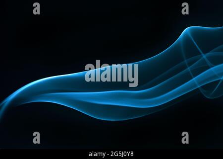 Blue smoke isolated on black background. Stock Photo
