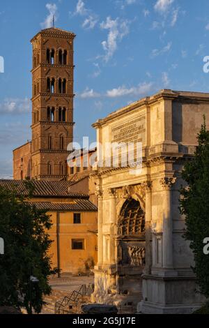 Italy, Rome, Arch of Titus built in AD 81 by the Emperor Domitian and Romanesque bell tower of Basilica of Saint Frances of Rome (Santa Francesca Roma Stock Photo