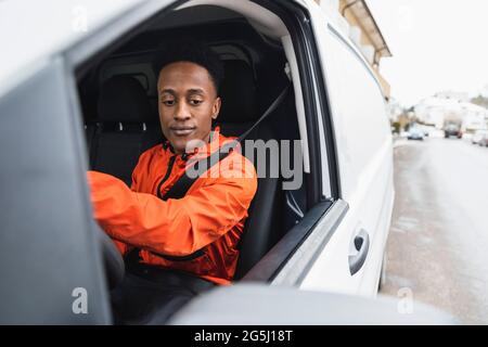 Young male driver driving delivery van Stock Photo