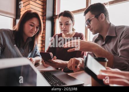 Teamwork of a business team in a modern office - Young people analyze the activities of their company - Young creative managers work in a new project Stock Photo