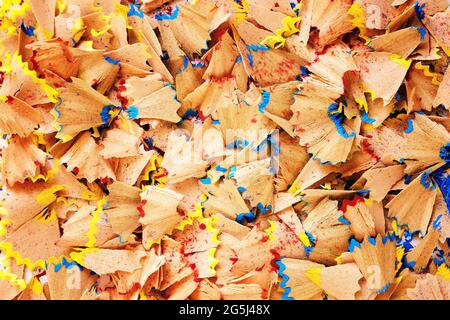 Sawdust from sharpening pencils fill the entire frame - Background image for text inscription - Shavings of colored pencils close-up - Concept of crea Stock Photo
