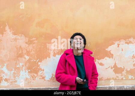 Italy, Tuscany, Pistoia, Woman in pink coat laughing Stock Photo