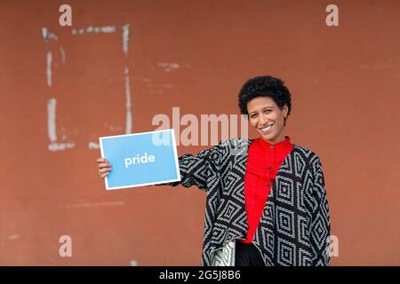 Italy, Tuscany, Pistoia, Smiling woman holding sign Stock Photo
