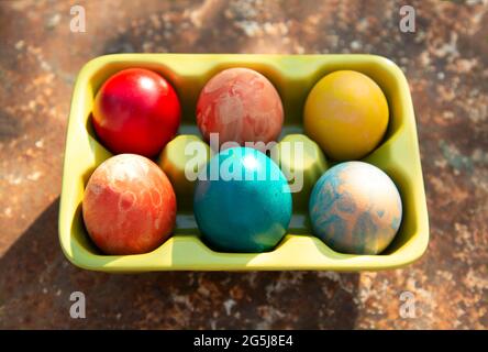 Italy, Turin, Colorful Eater eggs in egg carton Stock Photo