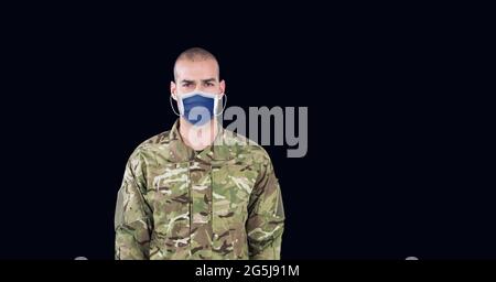 Composition of soldier wearing face mask standing to attention, against ...