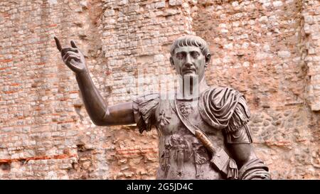 LONDON, UNITED KINGDOM - Feb 08, 2018: A statue of Roman Emperor Trajan with remains of London Wall which was first built by the Romans in the 2nd and Stock Photo