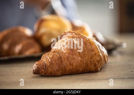 Freshly baked croissant on a table - Close up. Stock Photo