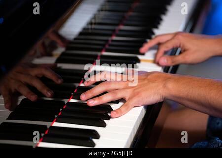 Close up of hands playing piano Stock Photo