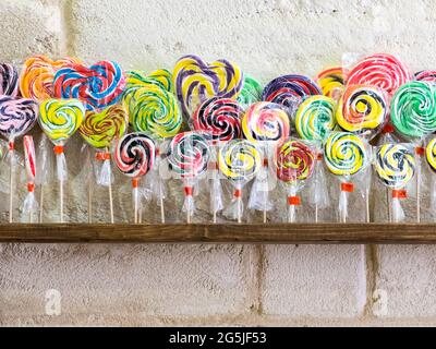 Colorful spiral lollipops over a shop shelf Stock Photo