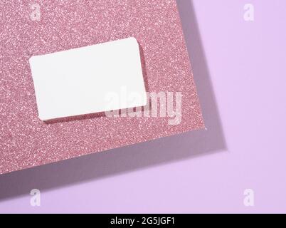 blank rectangular business card lies on a modern purple background sheets of paper with a shadow. Business template, flat lay Stock Photo
