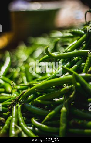 Green chilli peppers for sale at a street market. Green Chillis freshly ...