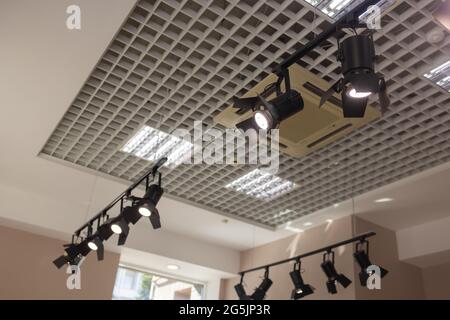 Spotlights under the ceiling on the wall. Track LED-lighting system Stock Photo