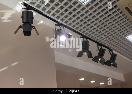 Spotlights under the ceiling on the wall. Track LED-lighting system Stock Photo