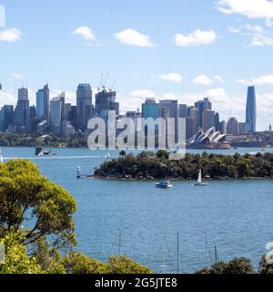 View of Sydney harbour and CDB on a beautiful sunny blue sky clear blue waters boats yachts and ferry residential and commercial buildings Australia Stock Photo