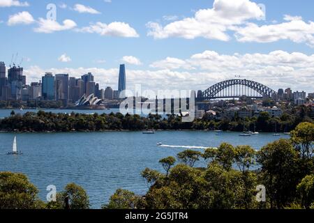 View of Sydney harbour and CDB on a beautiful sunny blue sky clear blue waters boats yachts and ferry residential and commercial buildings Australia Stock Photo