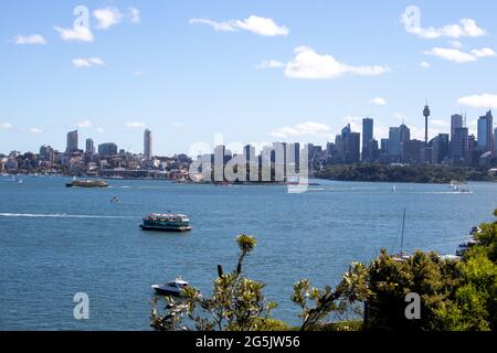 View of Sydney harbour and CDB on a beautiful sunny blue sky clear blue waters boats yachts and ferry residential and commercial buildings Australia Stock Photo