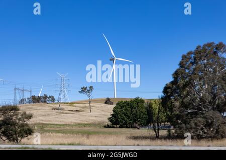 Electricity generating windmill Farms Hume Highway NSW Australia taken from moving car blurred foreground Stock Photo