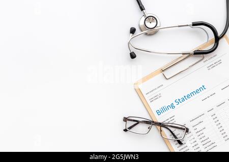 Medical billing statement with stethoscope. Top view Stock Photo