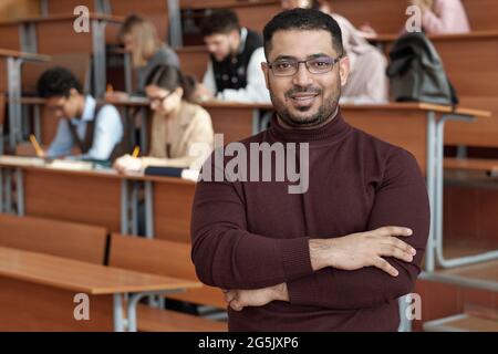 Successful teacher of university standing against group of students Stock Photo