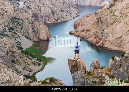 Man is standing on the cliff above the canyon of the Zrmanja River, Croatia Stock Photo