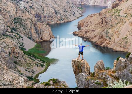 Man is standing on the cliff above the canyon of the Zrmanja River, Croatia Stock Photo